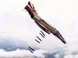 A U.S. Navy McDonnell F-4B Phantom II of Fighter Squadron VF-111 Sundowners drops 227 kg Mk 82 bombs over Vietnam during 1971. VF-111 was assigned to Attack Carrier Air Wing 15 (CVW-15) aboard the aircraft carrier USS Coral Sea (CVA-43) for a deployment to Vietnam from 12 November 1971 to 17 July 1972.