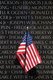 USA: A small American flag stands up against the Vietnam Veterans Memorial wall, Washington DC, 2010