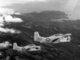 Vietnam: Two South Vietnamese Air Force North American T-28C Trojan aircraft flying over the Vietnamese coastline during a counterinsurgency training mission in 1962.